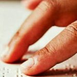 Image Showing Visually Impaired Person Reading Some Text.