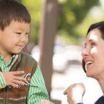 A Mother Talking Via Sign language To Her Cute Little Kid.