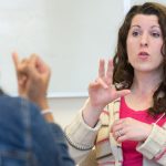 Two Young Ladies Talking Through Sign Language.