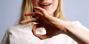 A Woman Speaking By Using Sign Language.