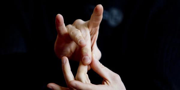 An Image Representing A Sign Language Icon In A Black Background.