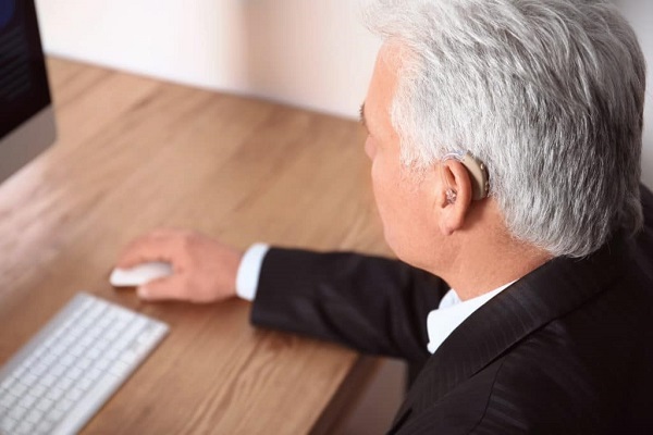 A Corporate Business Man Having Hearing Disability Working In Office.